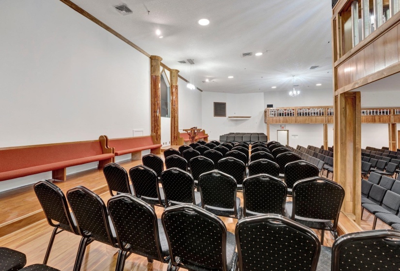 Cinema with ornamental molding and light hardwood / wood-style floors