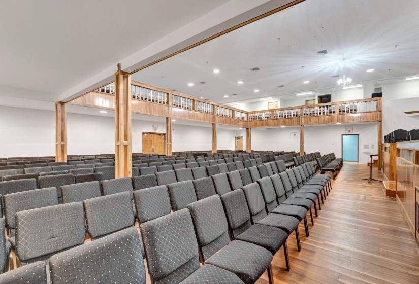 Cinema featuring wood-type flooring and ornate columns