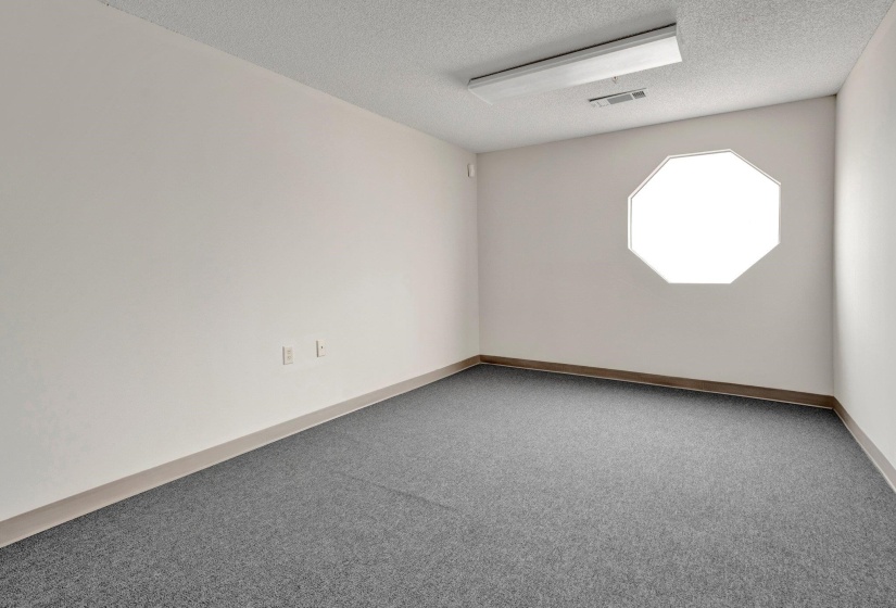 Spare room featuring carpet floors and a textured ceiling