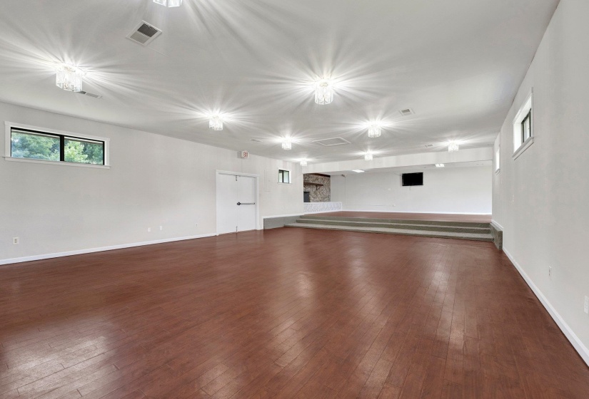 Unfurnished living room featuring dark hardwood / wood-style flooring