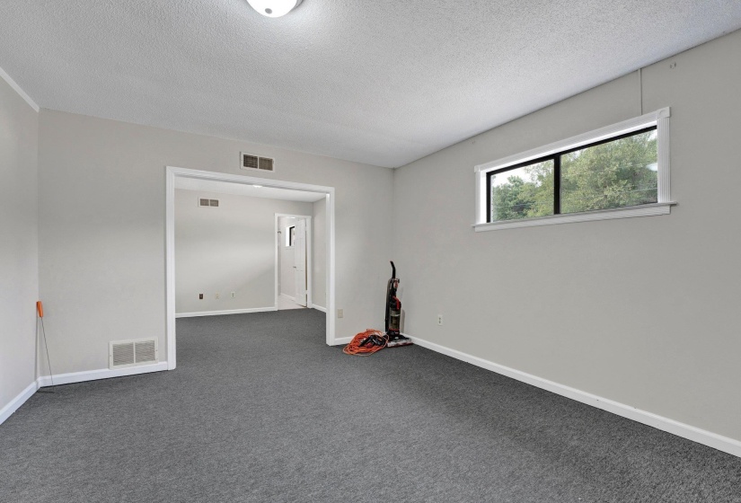 Carpeted empty room featuring a textured ceiling