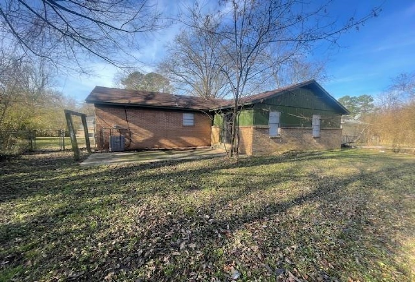 Rear view of property featuring brick siding