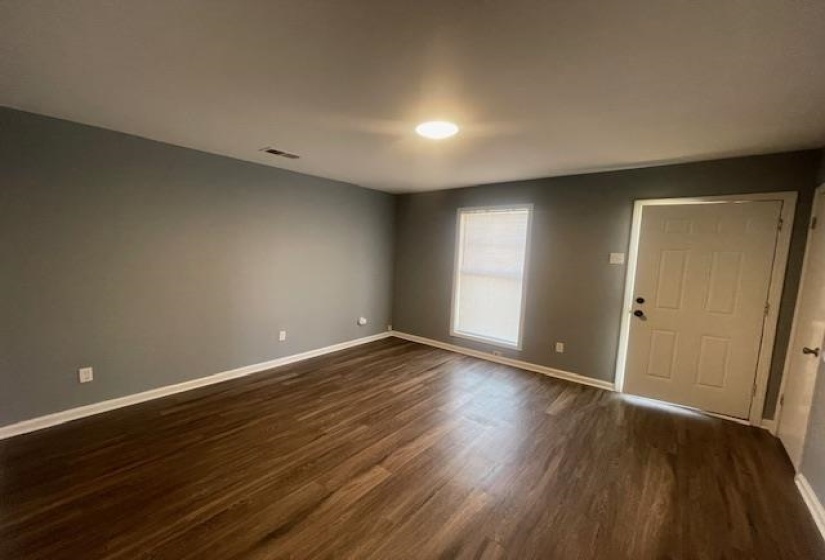 Entrance foyer with baseboards and dark wood-type flooring