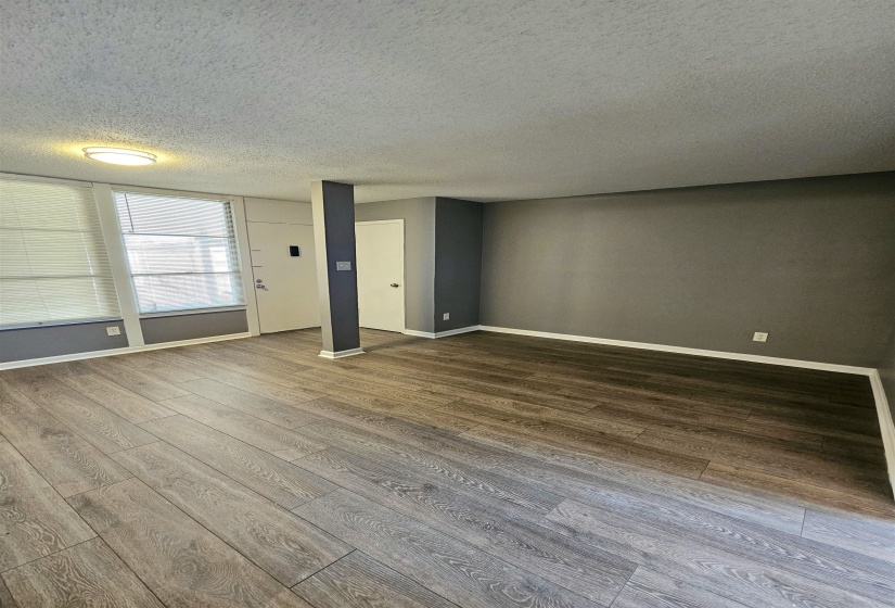 Spare room with a textured ceiling and wood finished floors