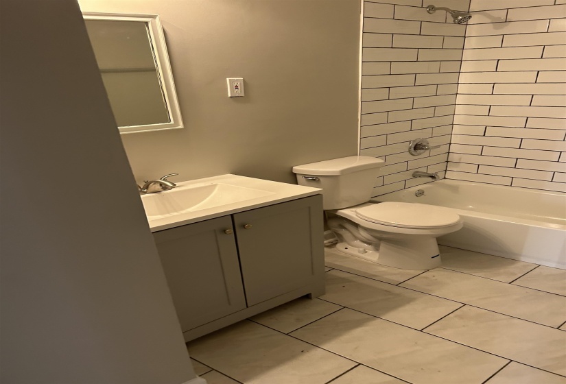 Full bath featuring vanity and bathtub / shower combination