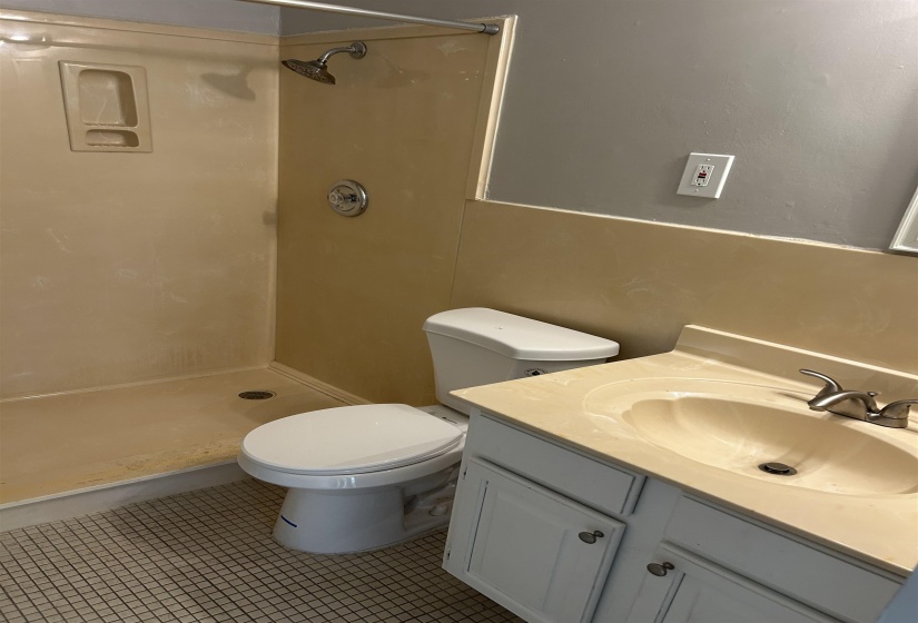 Bathroom featuring a shower, vanity, and tile patterned floors