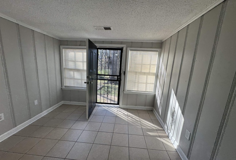 Foyer featuring light tile patterned floors and a textured ceiling