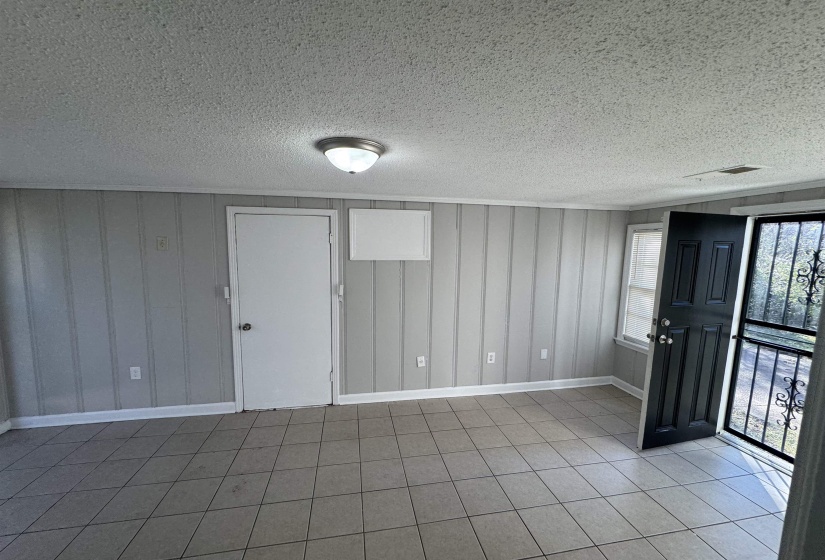 Entryway featuring a textured ceiling and tile patterned floors