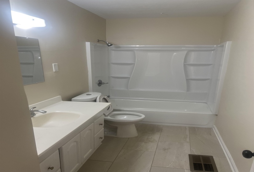 Bathroom featuring vanity and washtub / shower combination