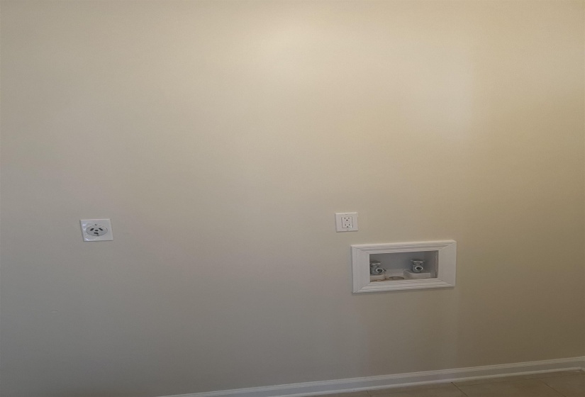 Washroom featuring hookup for a washing machine, hookup for an electric dryer, and light tile patterned floors