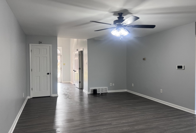 Spare room featuring dark wood finished floors and a ceiling fan