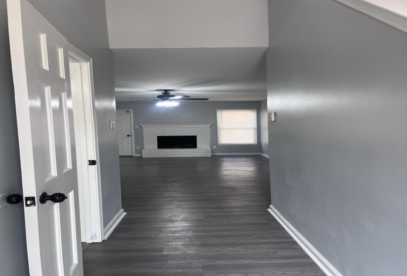 Hallway with baseboards and dark wood finished floors