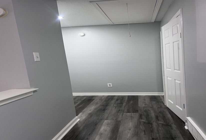 Foyer access and dark wood-type flooring