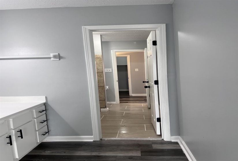 Bathroom featuring vanity, dark wood-type flooring, and a textured ceiling