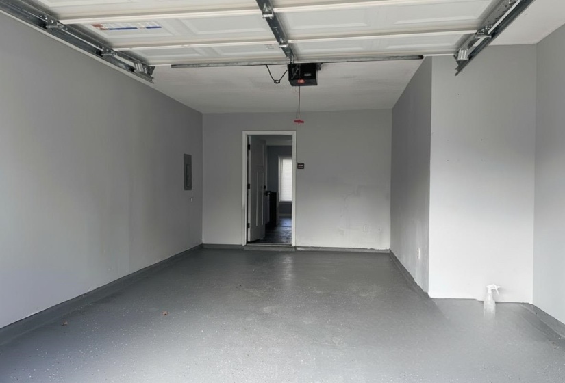 Garage with a garage door opener and electric panel