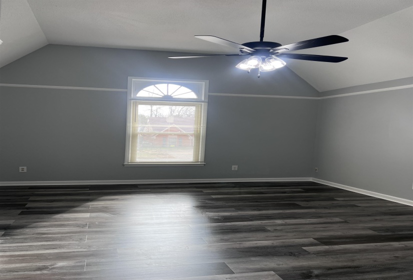 Bonus room featuring lofted ceiling and dark wood-style floors