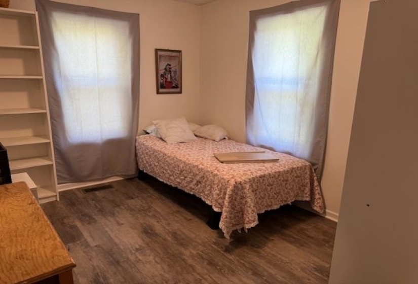 Bedroom with dark wood-style floors