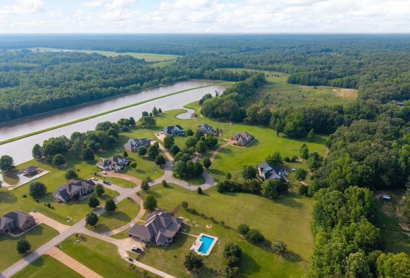 Aerial view of a heavily wooded area and a large body of water