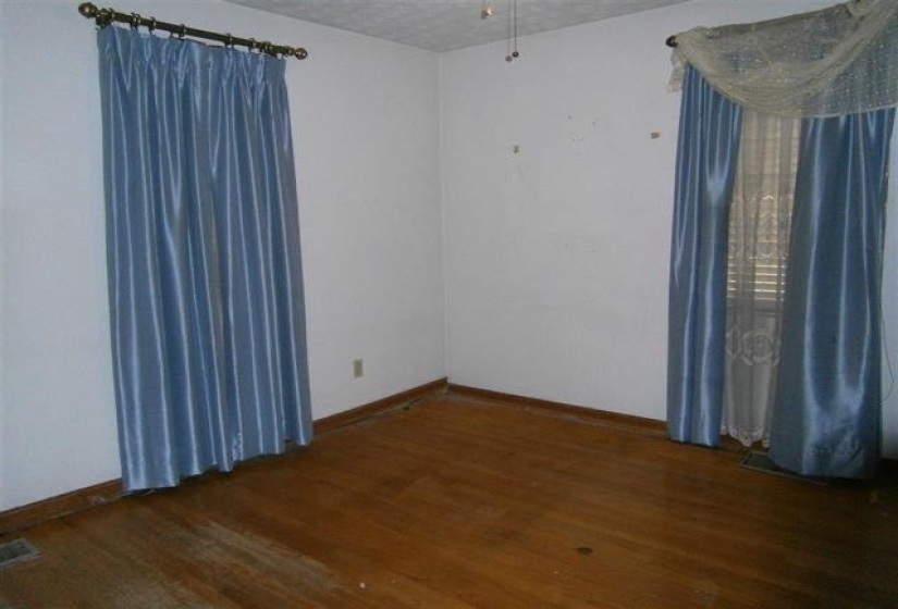 Unfurnished room featuring wood finished floors and baseboards