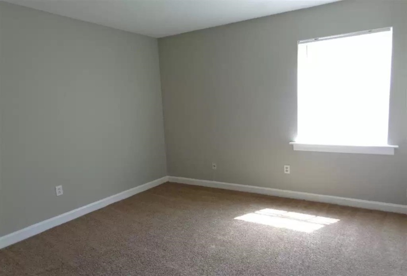 Unfurnished room with carpet floors and baseboards