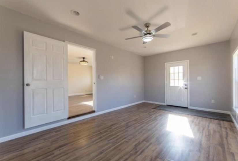 Spare room featuring dark wood-type flooring and a ceiling fan