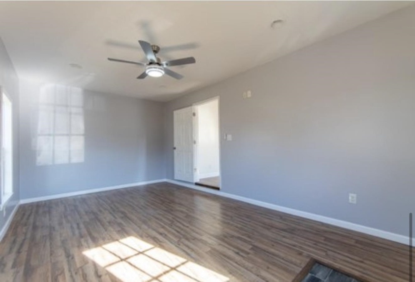 Empty room featuring wood finished floors and ceiling fan