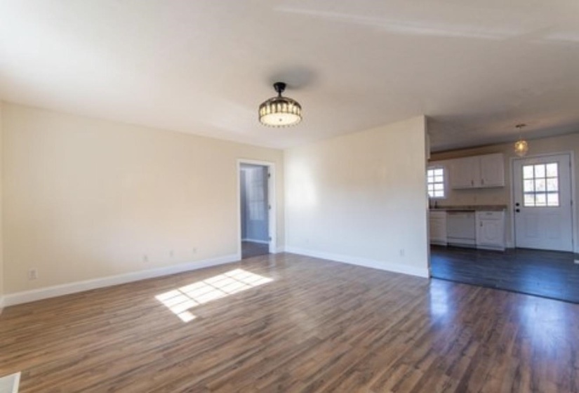 Unfurnished living room with dark wood finished floors