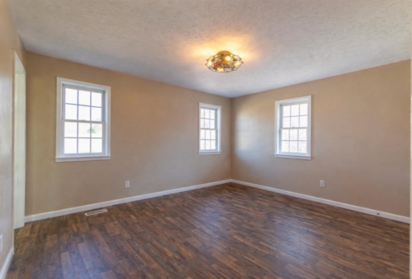 Unfurnished room with dark wood finished floors and a textured ceiling