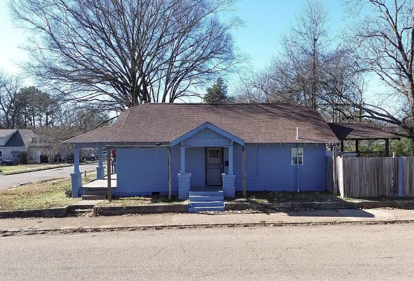 View of front of home featuring covered porch and roof with shingles
