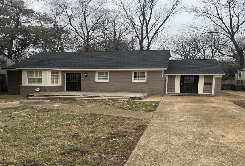 Ranch-style house with brick siding, roof with shingles, and driveway