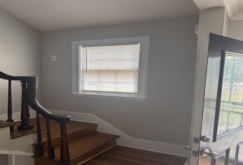 Staircase featuring wood finished floors and baseboards