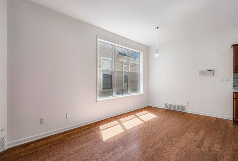 Empty room with dark wood finished floors and baseboards