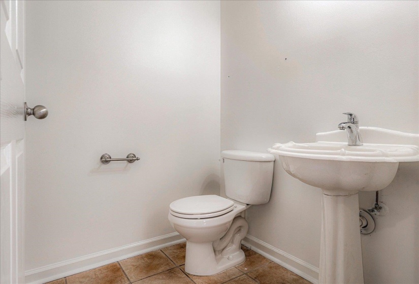 Bathroom with baseboards and light tile patterned floors