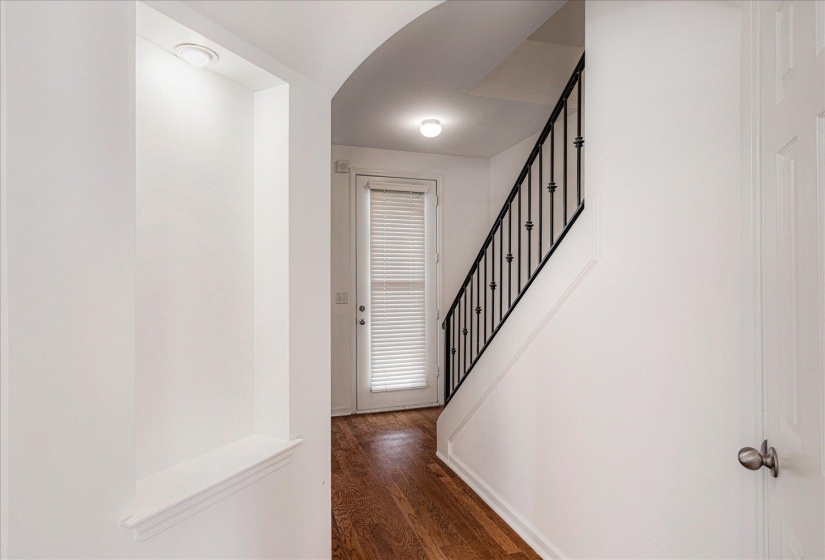 Hall featuring stairway and dark wood-style floors