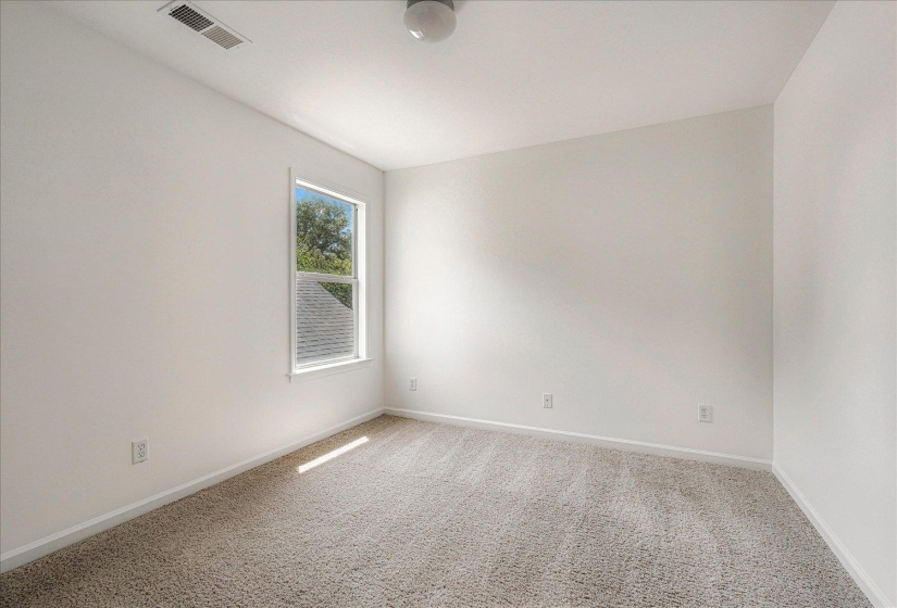 Carpeted empty room with baseboards