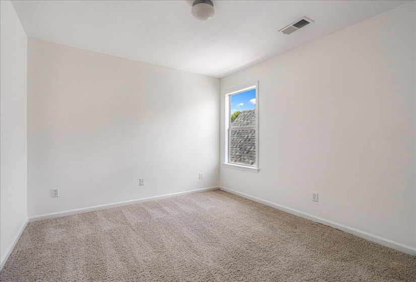Empty room featuring carpet and baseboards