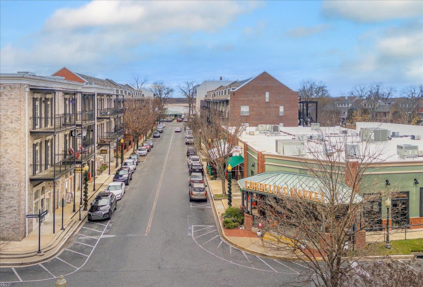 View of asphalt street featuring curbs and sidewalks