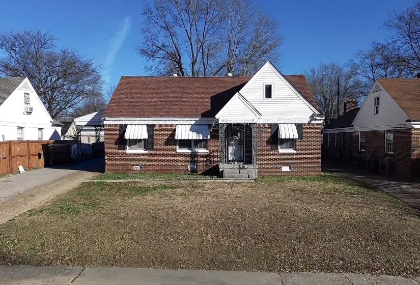 Bungalow-style house featuring brick siding and a shingled roof