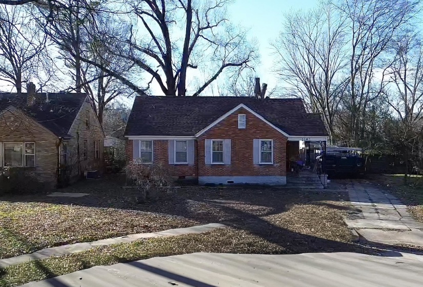View of front of property with brick siding, crawl space, and concrete driveway