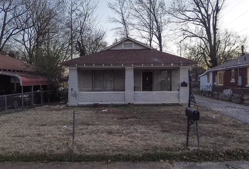 View of front of house featuring brick siding, a porch, and roof with shingles
