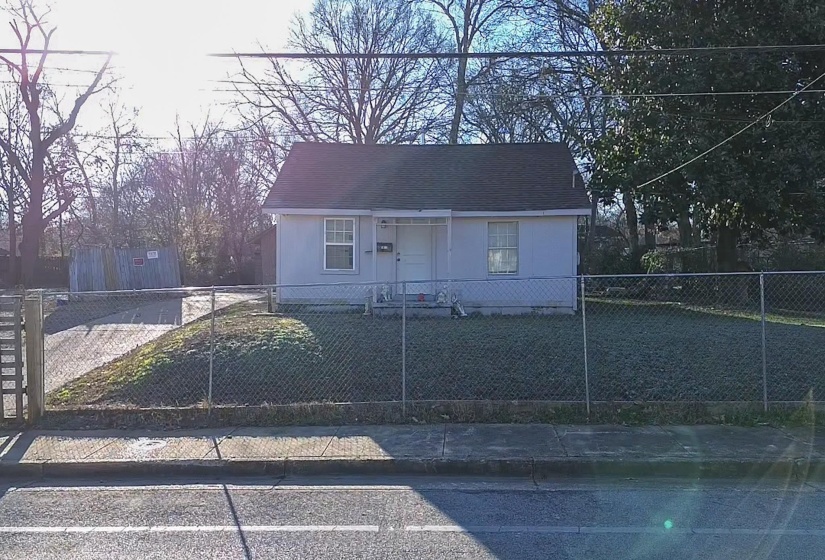 Bungalow-style house with a fenced front yard and roof with shingles