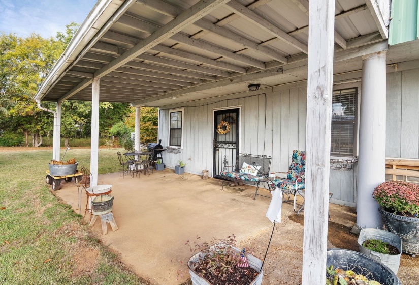 View of patio with a grill