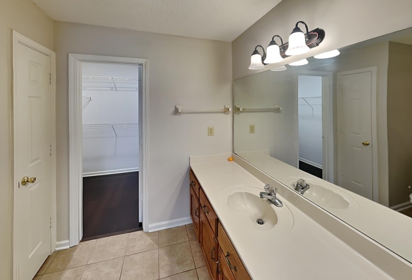 Bathroom featuring vanity, a textured ceiling, and tile patterned floors