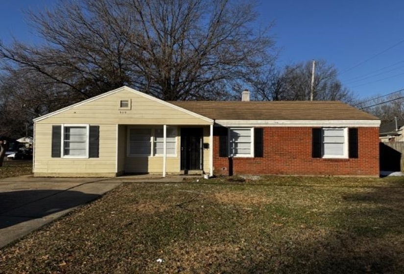 Single story home featuring brick siding, a front yard, and covered porch