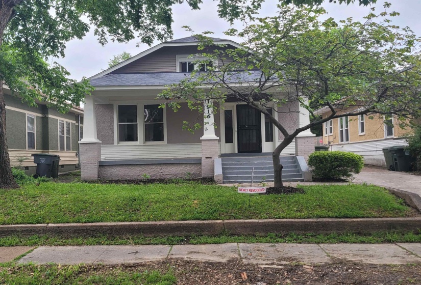Bungalow-style house with a porch, a front yard, and roof with shingles