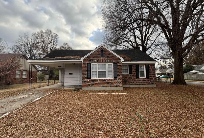 Bungalow with concrete driveway, covered porch, an attached carport, brick siding, and roof with shingles