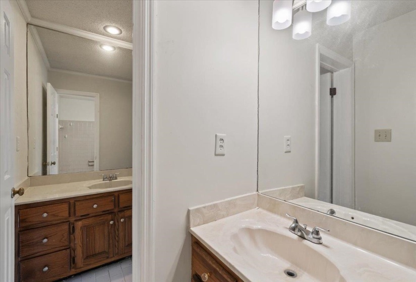 Full bathroom with vanity, a textured ceiling, and light tile patterned floors