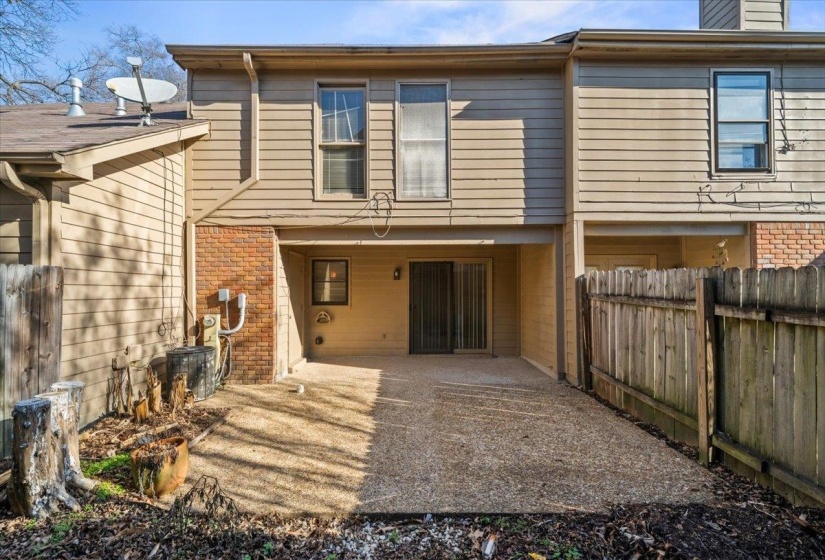 Rear view of property with a patio, brick siding, and a chimney