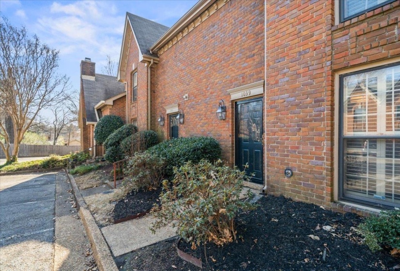 View of property exterior with brick siding