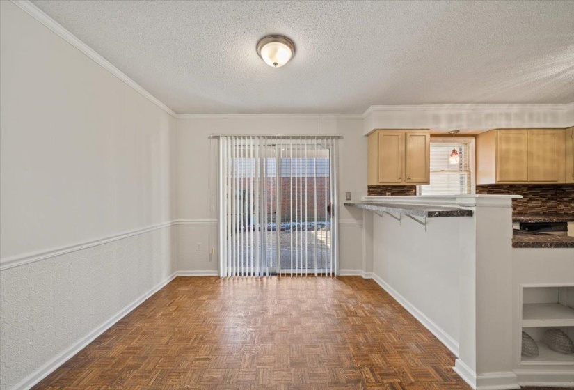Unfurnished dining area with a textured ceiling and ornamental molding